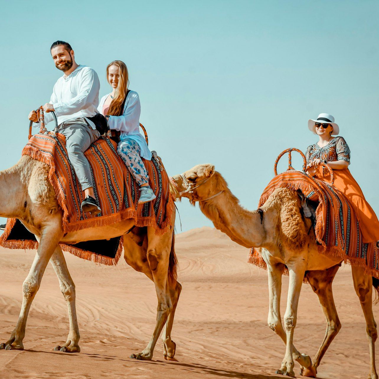 Explore the stunning desert landscape as you ride camels through golden sands enjoying the unique experience of Dubai's rich culture and breathtaking scenery. Capture unforgettable memories.